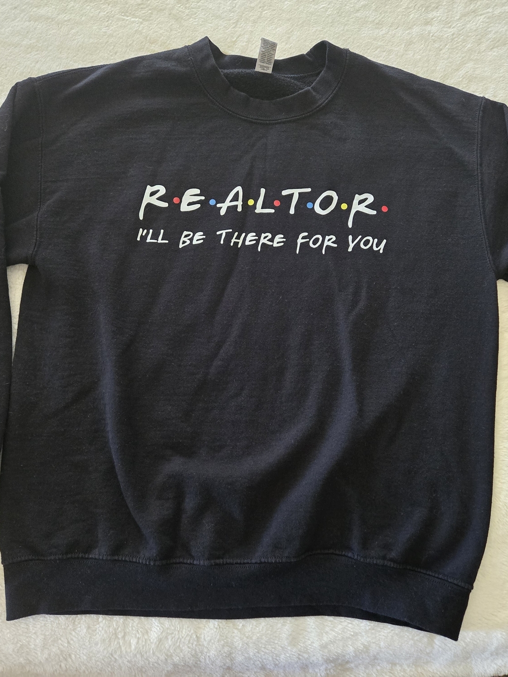 Friends Inspired Black Crewneck Sweater with Multicolor 'R.E.A.L.T.O.R.' Graphic